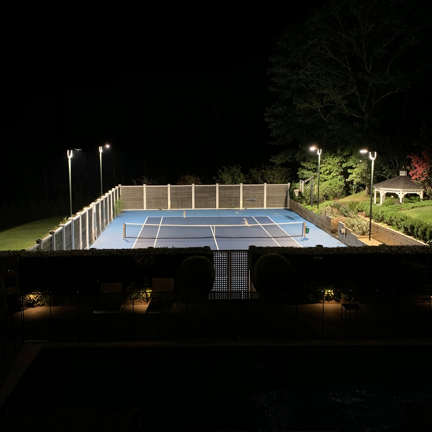 LED Light Fixtures + Hunter Green Light Poles for Backyard Tennis Court Lighting Project
